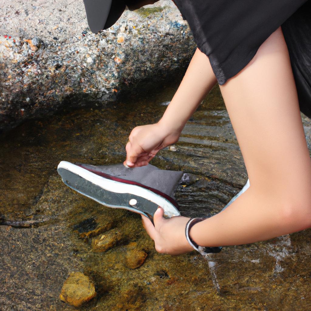 Person testing shoe water resistance